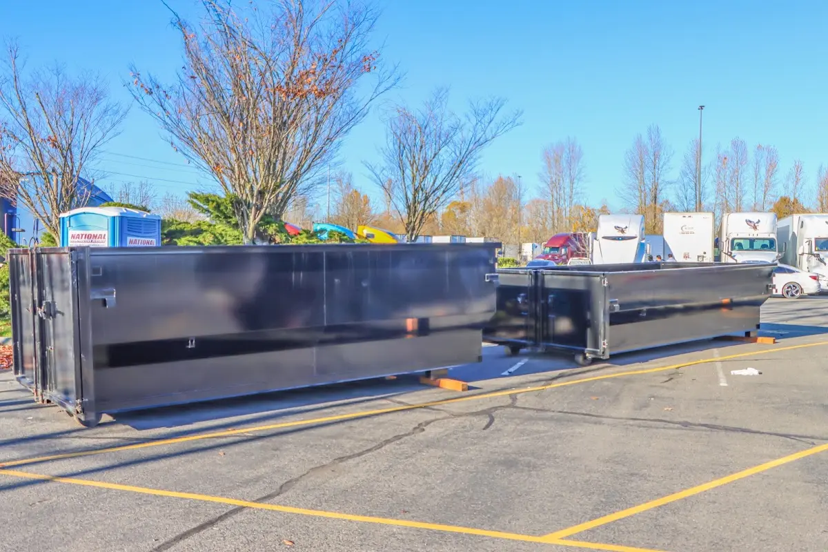 Professional dumpster rental service with roll-off container on residential driveway in Argentine